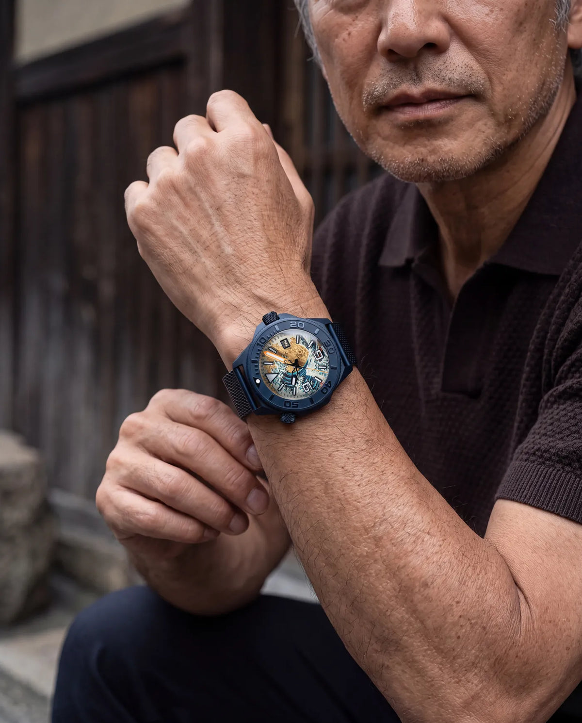 Worn by an older man crouched in a narrow wooden street