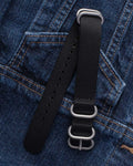 20mm black NATO watch strap laid on denim