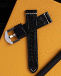 22mm black alligator-pattern leather watch strap, lifestyle photo on yellow background